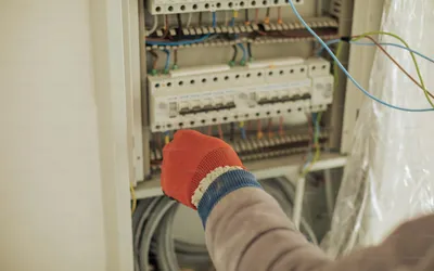 a worker fixing an electrical panel