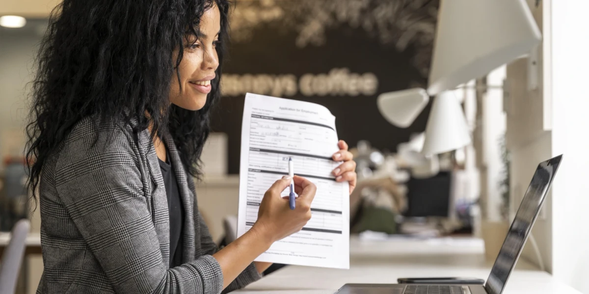 A freelance creating a professional invoice on a laptop using QuickAdminSoftware's free invoice software.
