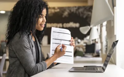 A freelance creating a professional invoice on a laptop using QuickAdminSoftware's free invoice software.