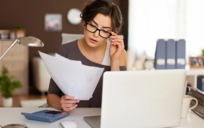 image of a woman looking at invoices in her office