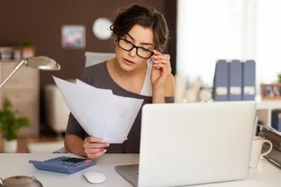 image of a woman looking at invoices in her office