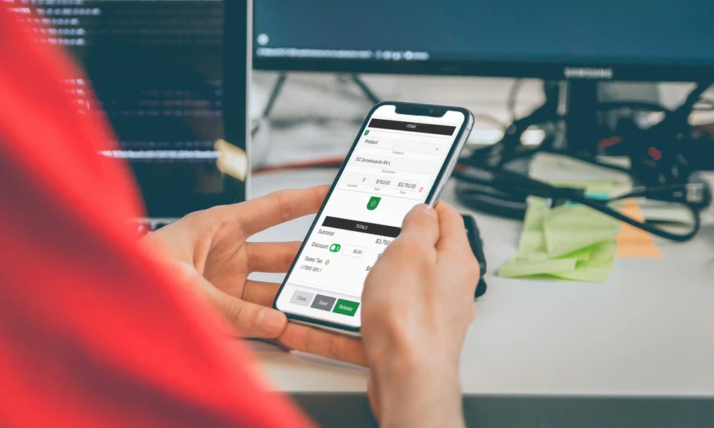 person-handling-a-quickadmin-software-progressive-web-application-in--mobile